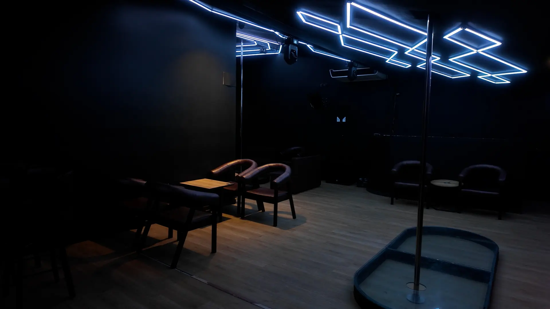 Pole dance stage surrounded by tables at Club Fase II, El Poblado, Medellín